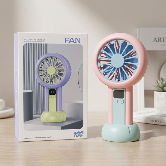 Colorful handheld fan with packaging on a wooden surface